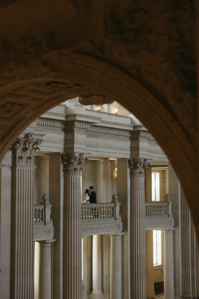 documentary photo of bride and groom in San Francisco City Hall