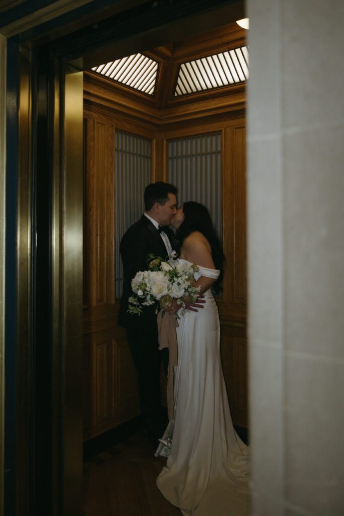 Bride and Groom kissing in elevator