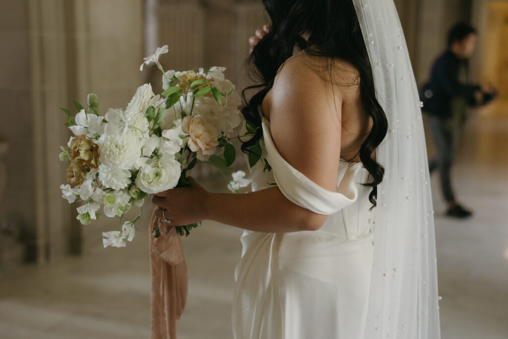 Bride holding bouquet in the iconic San Francisco City Hall