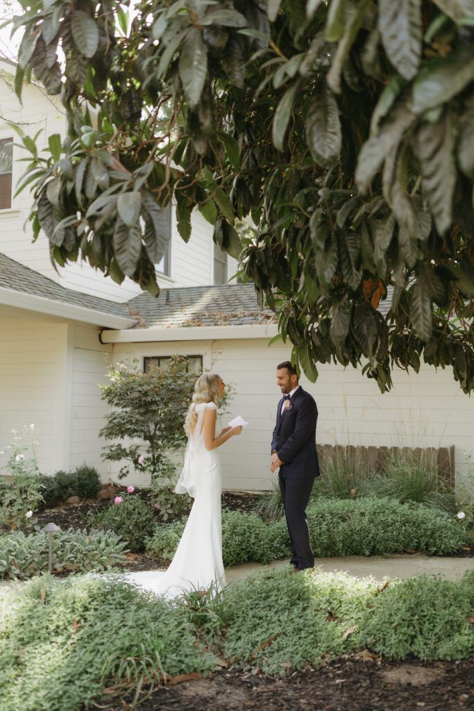 Emotional first look between bride and groom, capturing the moment they see each other for the first time on their wedding day