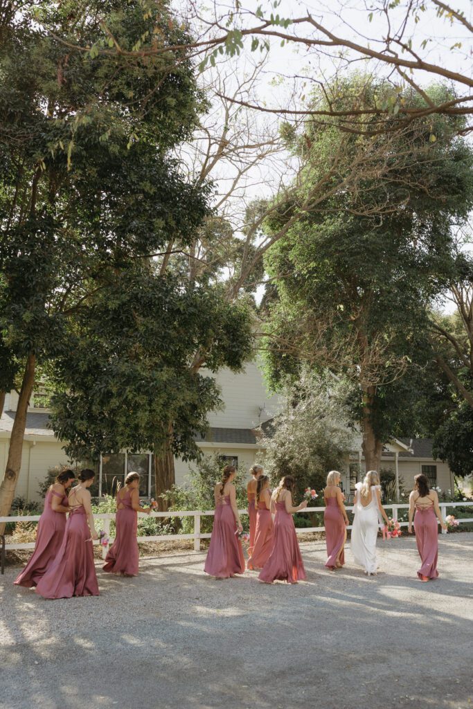 bride and bridesmaids taking a quiet stroll together before festivities begin