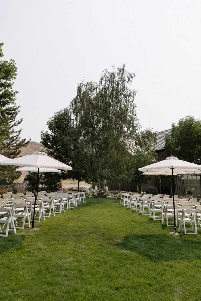 Outdoor wedding ceremony at white barn in Idaho