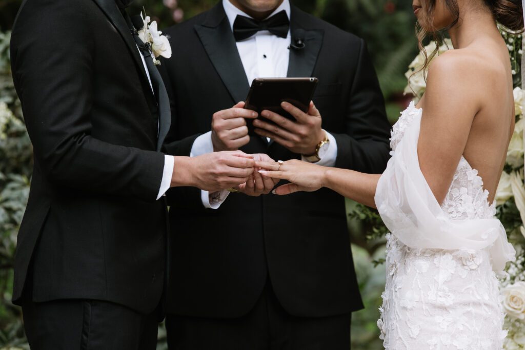 bride and groom exchange rings during ceremony at Big Sur wedding.