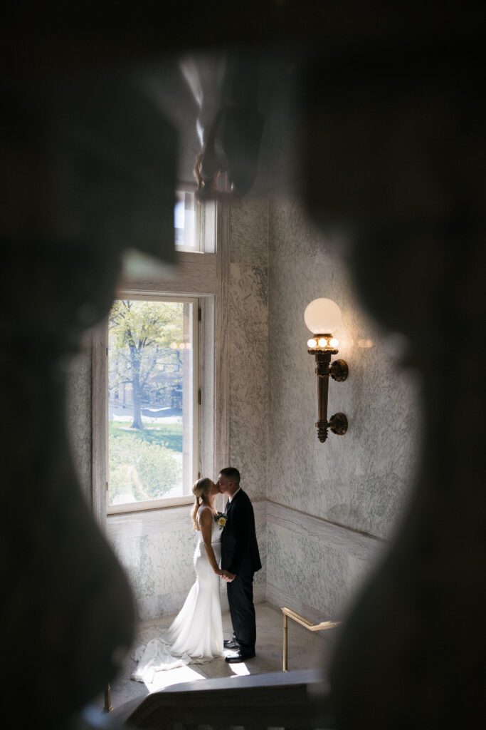 Newlyweds walking through the marble halls of the Idaho State Capitol.