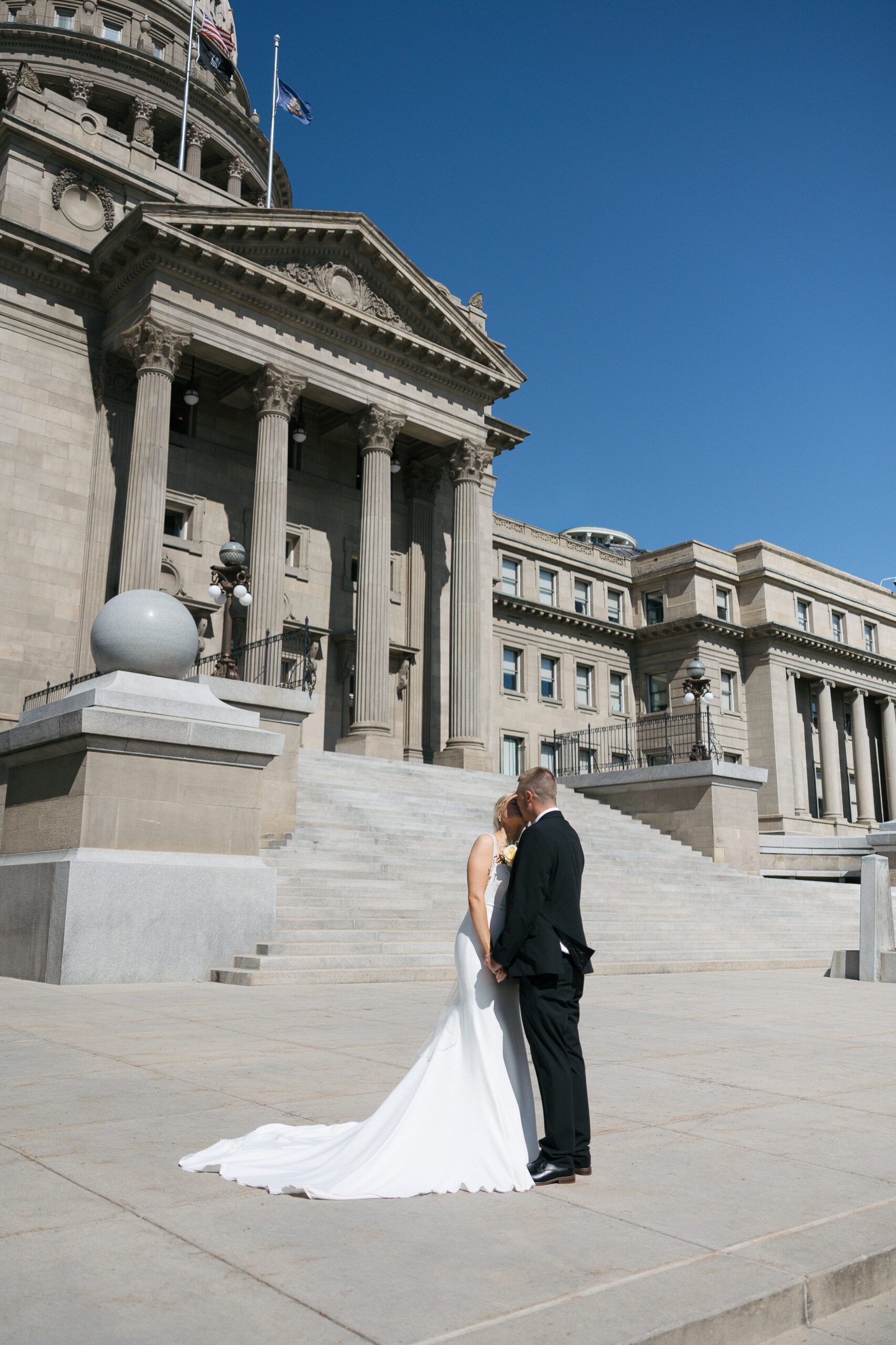 Couple standing together outside the Idaho State Capitol after their elopement
