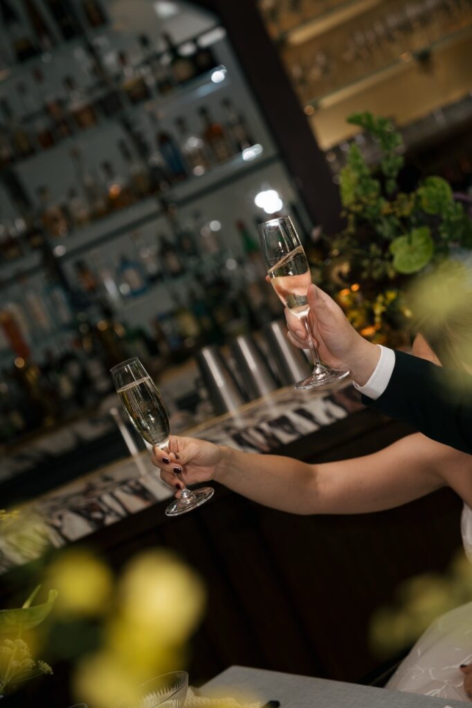 Bride and groom celebrate with a toast during cocktail hour at a Boise wedding.