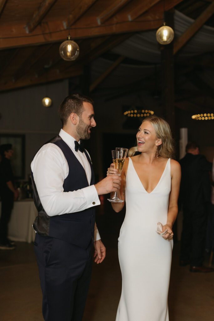 Bride and groom celebrate together during their cocktail hour.