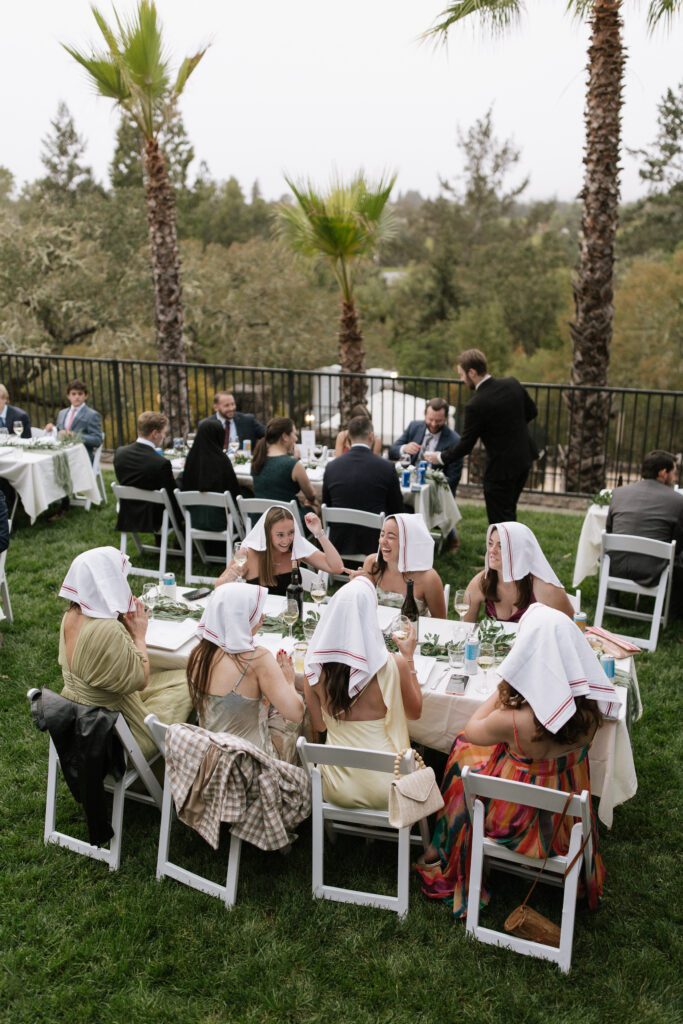 Guests celebrating during outdoor wedding reception.