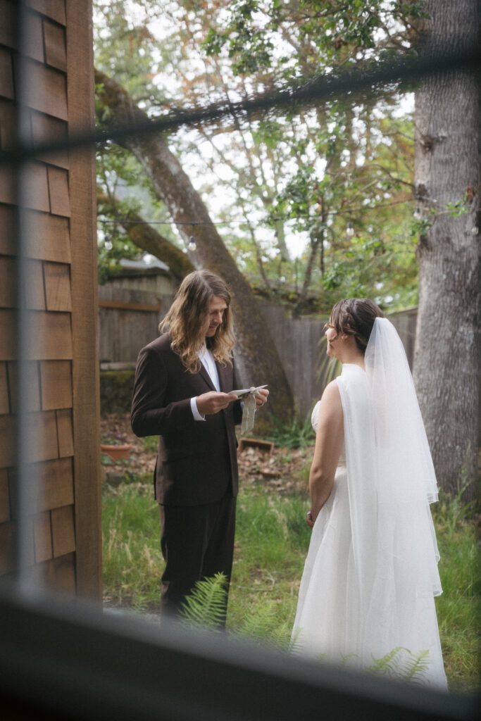 Couple reading private vows during their Oregon elopement.