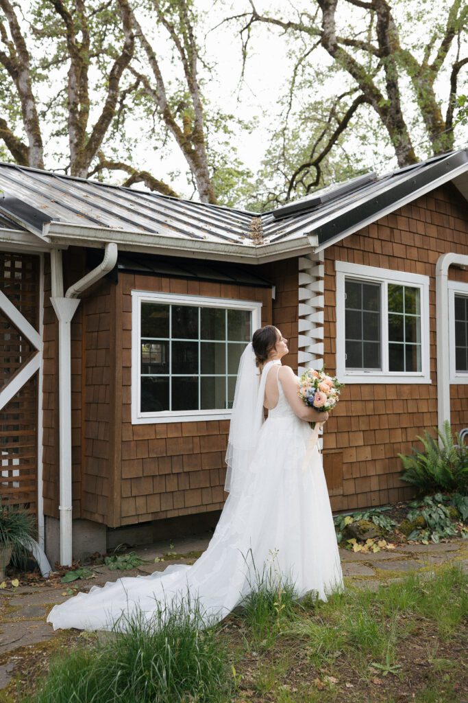 Bride poses with bouquet during intimate Oregon elopement.