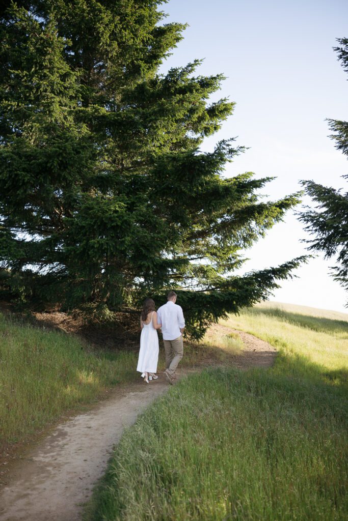 Couple walking hand in hand along a trail at Mount Tamalpais.
