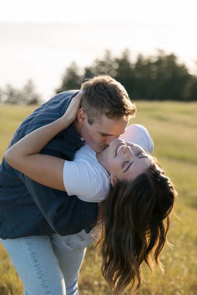 Bride and groom-to-be laugh in a candid moment during engagement photos at Mount Tamalpais State Park.