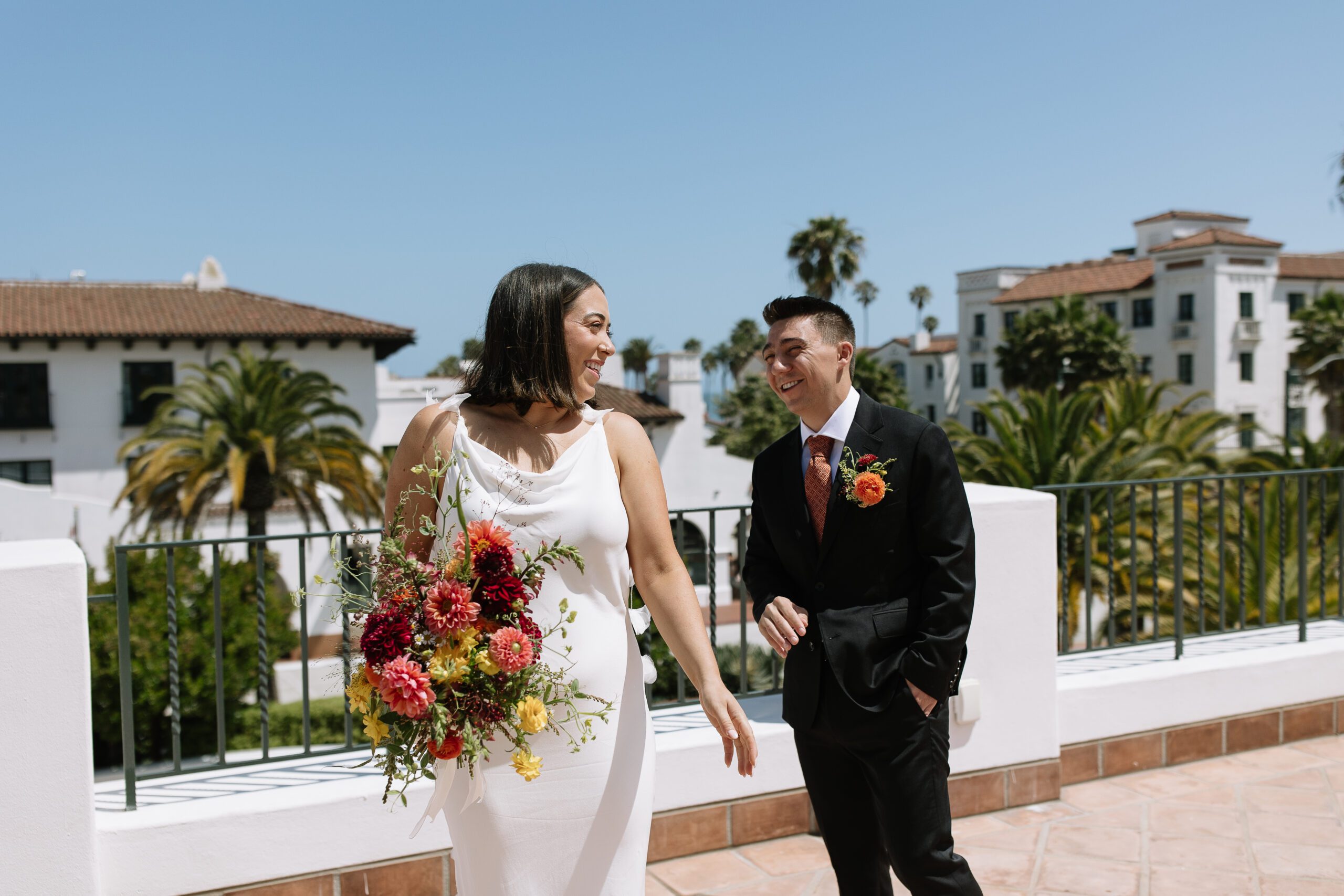 Couple standing together outside the Santa Barbara Courthouse after their elopement.