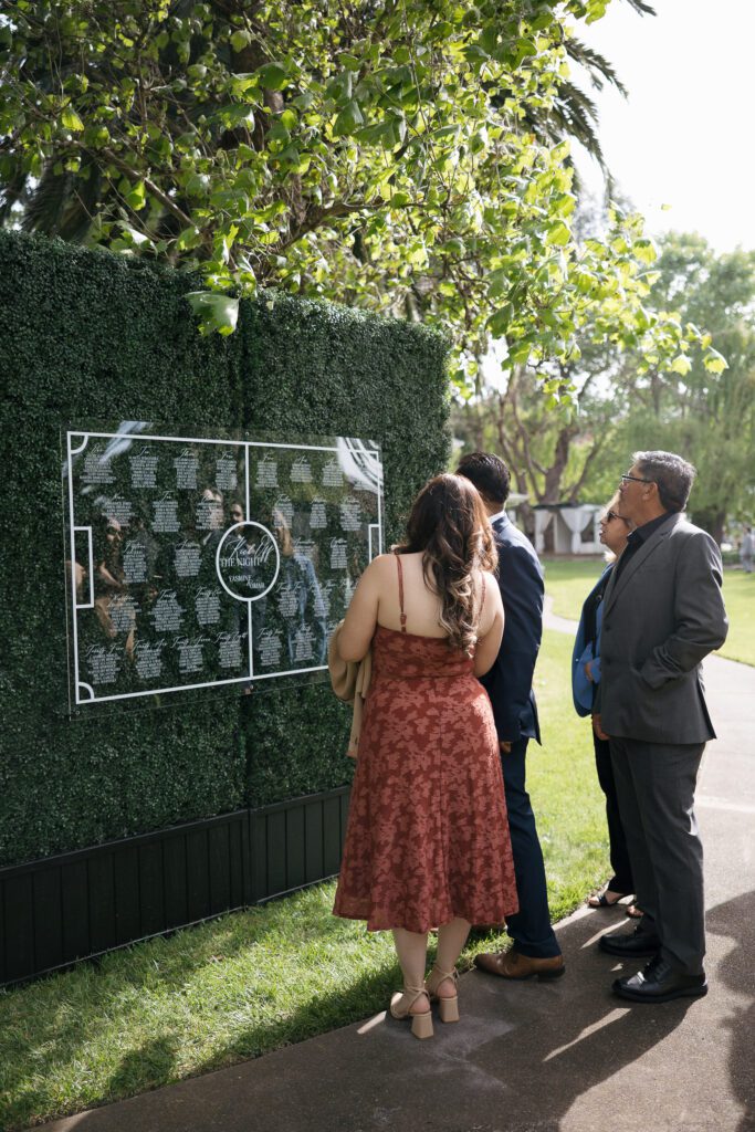 Guests checking seating chart during elegant wedding at Cline Cellars in Sonoma.
