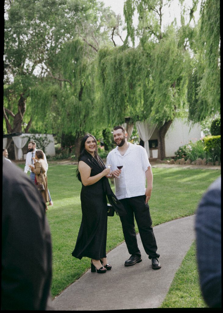 Guests pose for photos at Cline Cellars wedding in Sonoma.