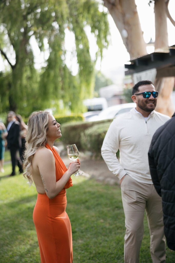 Guests laughing during outdoor wedding reception at Cline Cellars in Sonoma.