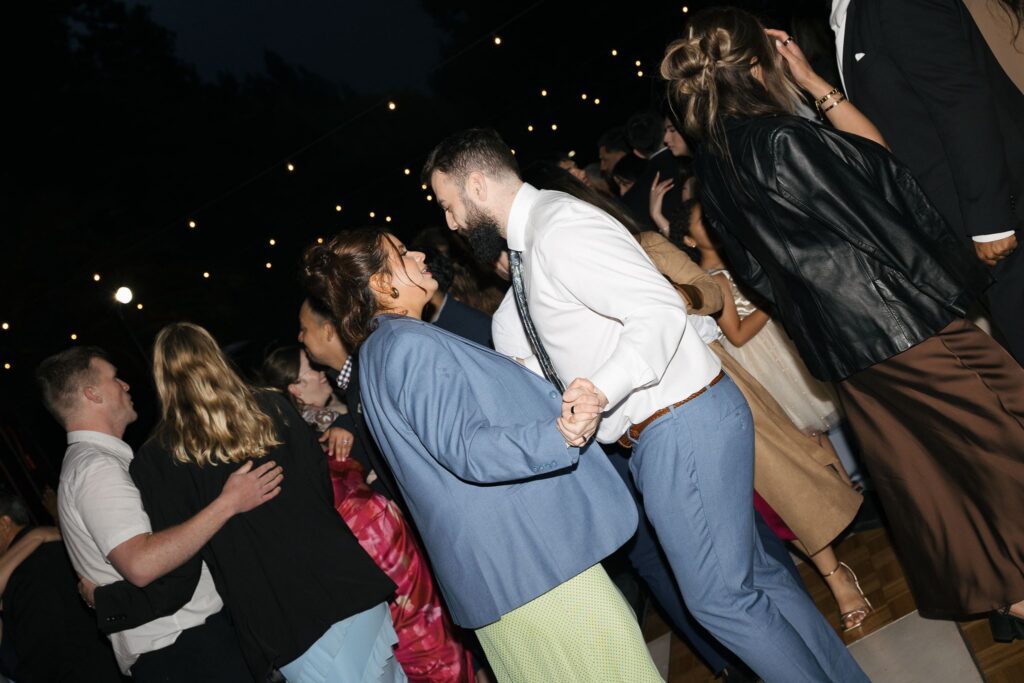 creative flash photography of guests dancing during wedding reception.
