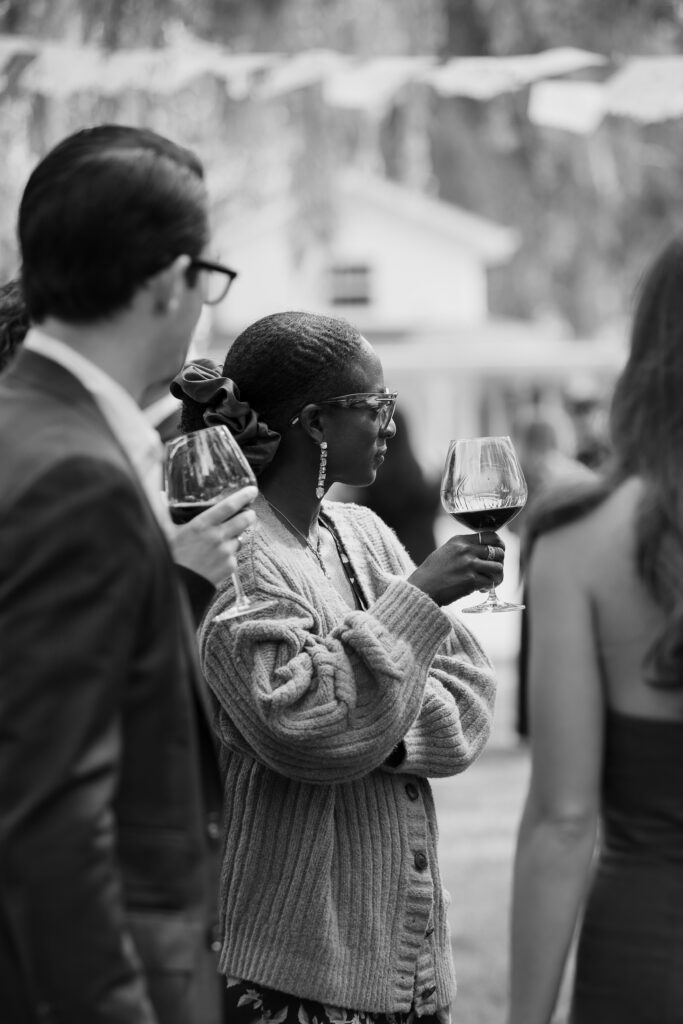 Guest raises champagne glass during toasts at Cline Cellars wedding reception in Sonoma.