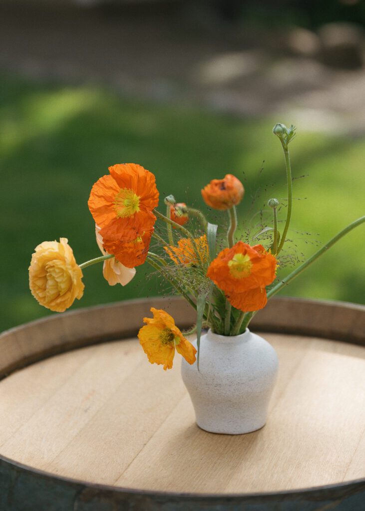 Floral wedding details during outdoor reception at Cline Cellars in Sonoma, California.