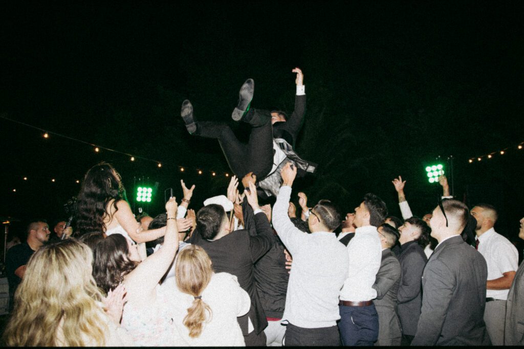 Bride and groom celebrating with guests during their California wedding reception.