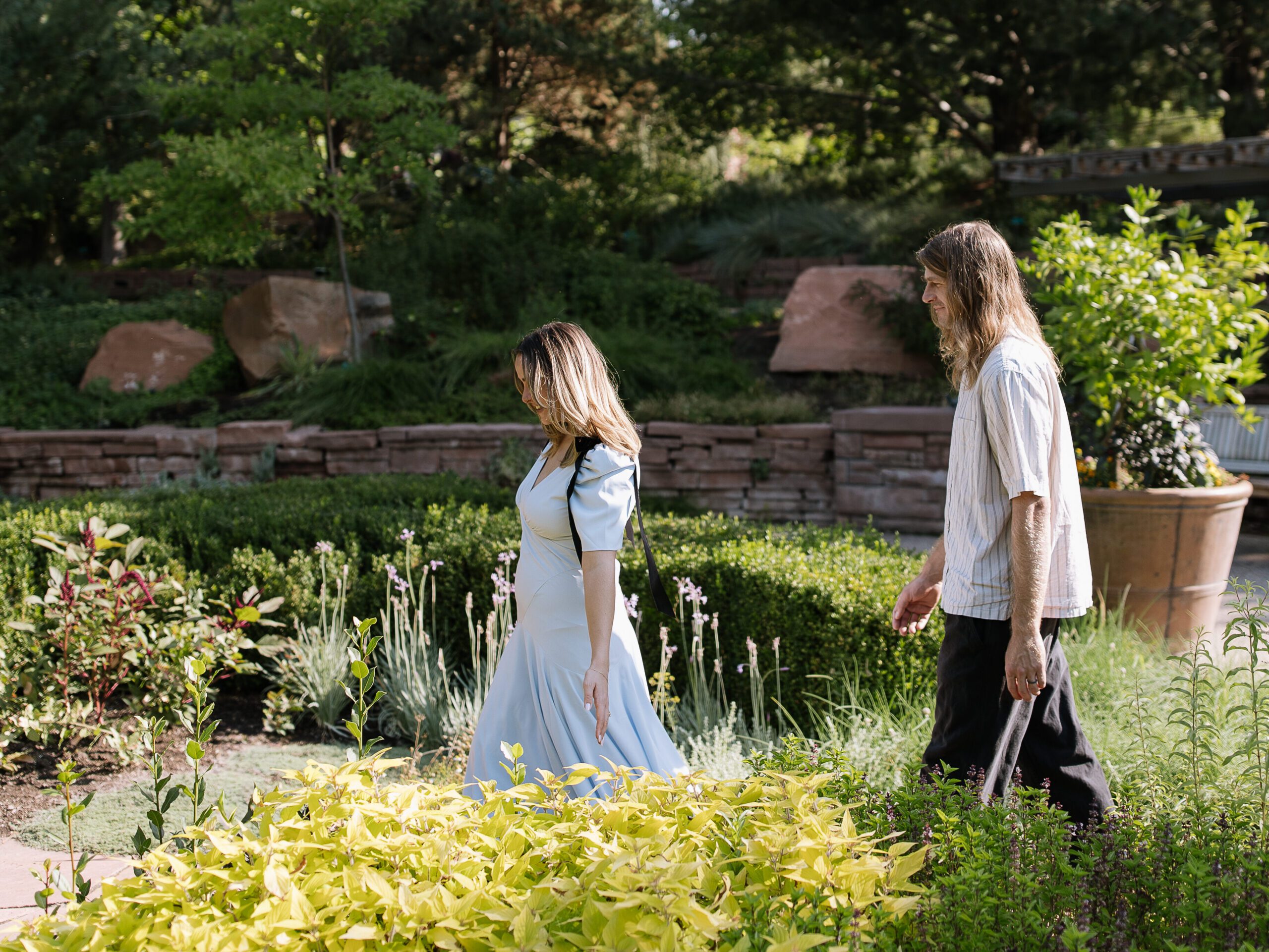 Couple walking together through Red Butte Garden during their engagement session.