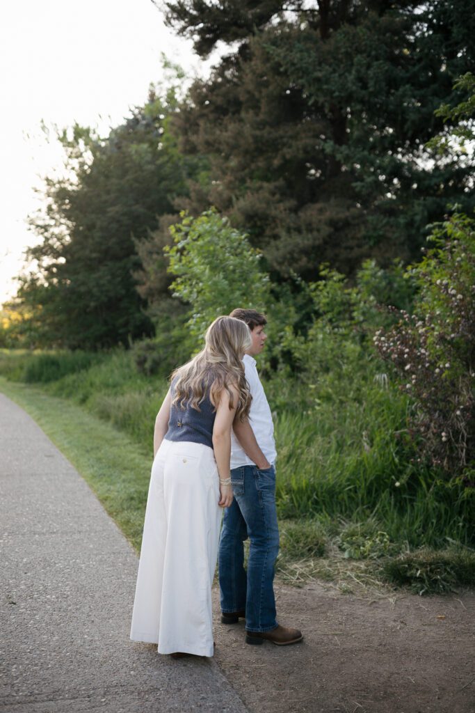 Documentary-style engagement portraits in a peaceful Boise garden setting.
